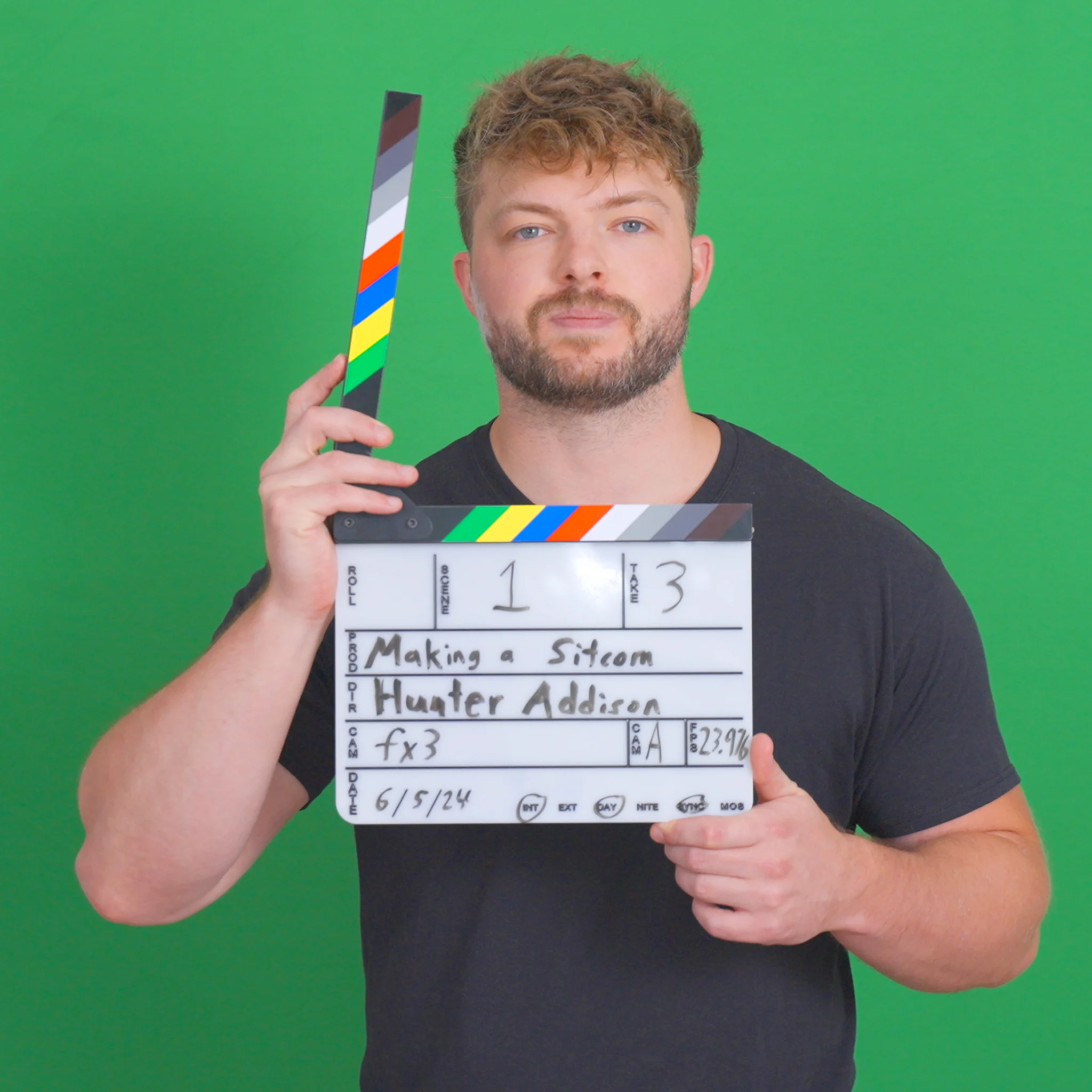 Hunter Addison holding a video clapperboard.